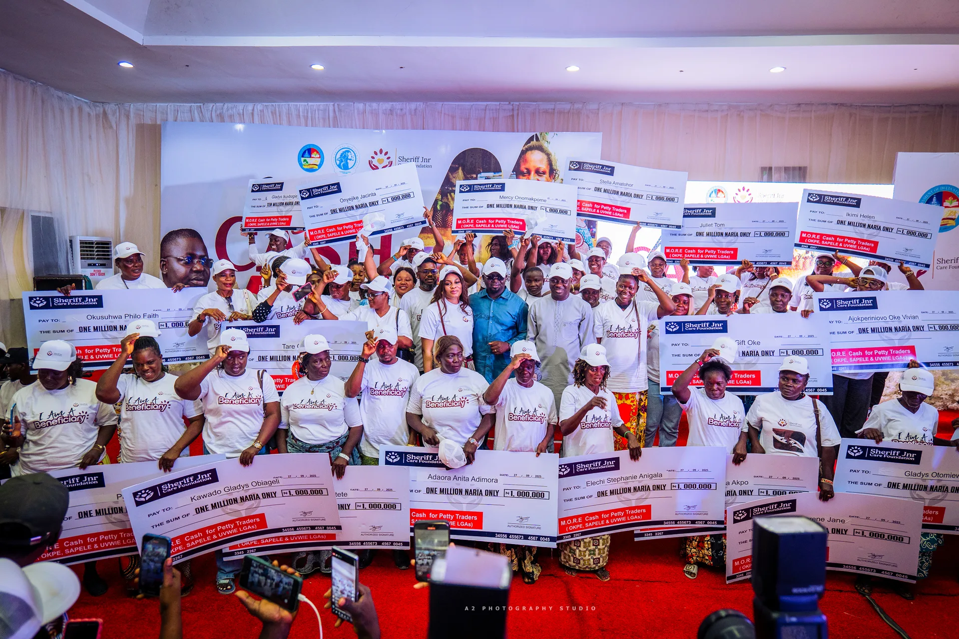 A group photograph with presentation cheques.
